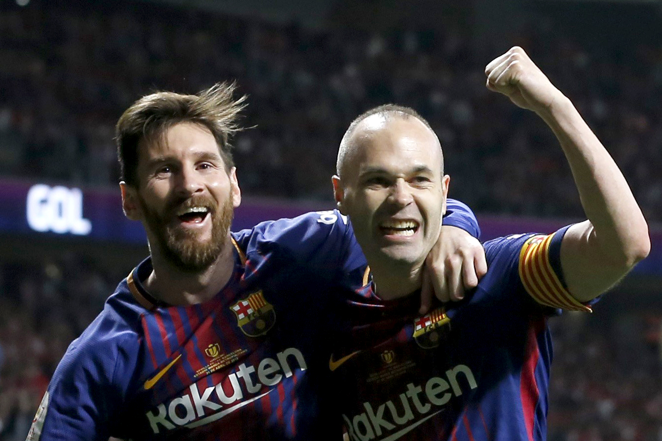 epaselect epa06684478 FC Barcelona's midfielder Andres Iniesta (R) celebrates with Argentinian striker Lionel Messi (L) after scoring the 4-0 lead during the Spanish King's Cup final soccer match between Sevilla FC and FC Barcelona played at Wanda Metropolitano stadium in Madrid, Spain, 21 April 2018. EPA-EFE/Ballesteros