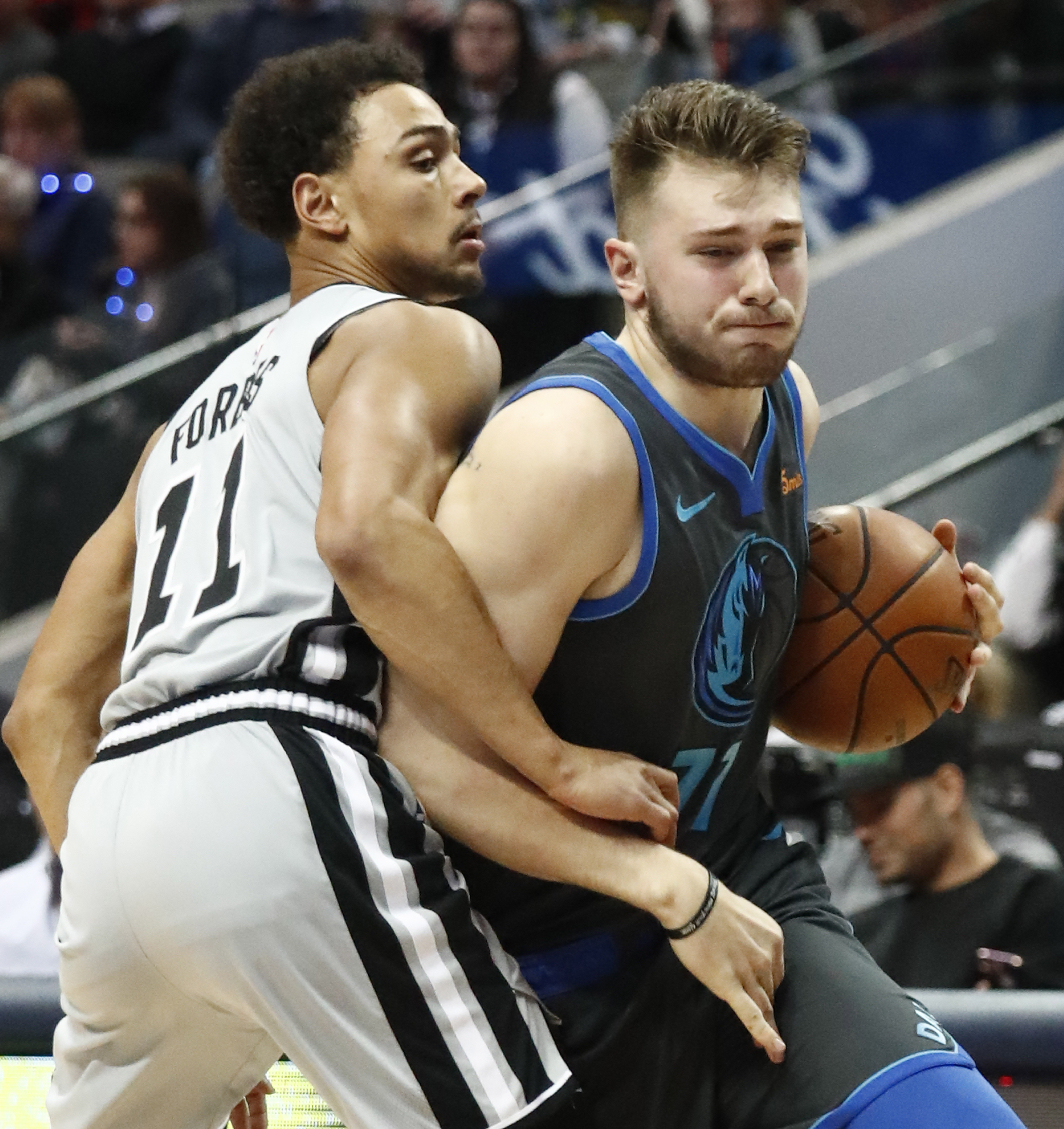 epa07291216 Dallas Mavericks player Luka Doncic (R) of Slovenia goes to the basket against San Antonio Spurs player Bryn Forbes (L) in the first half of their NBA basketball game at the American Airlines Center in Dallas, Texas, USA, 16 January 2019. EPA-EFE/LARRY W. SMITH SHUTTERSTOCK OUT