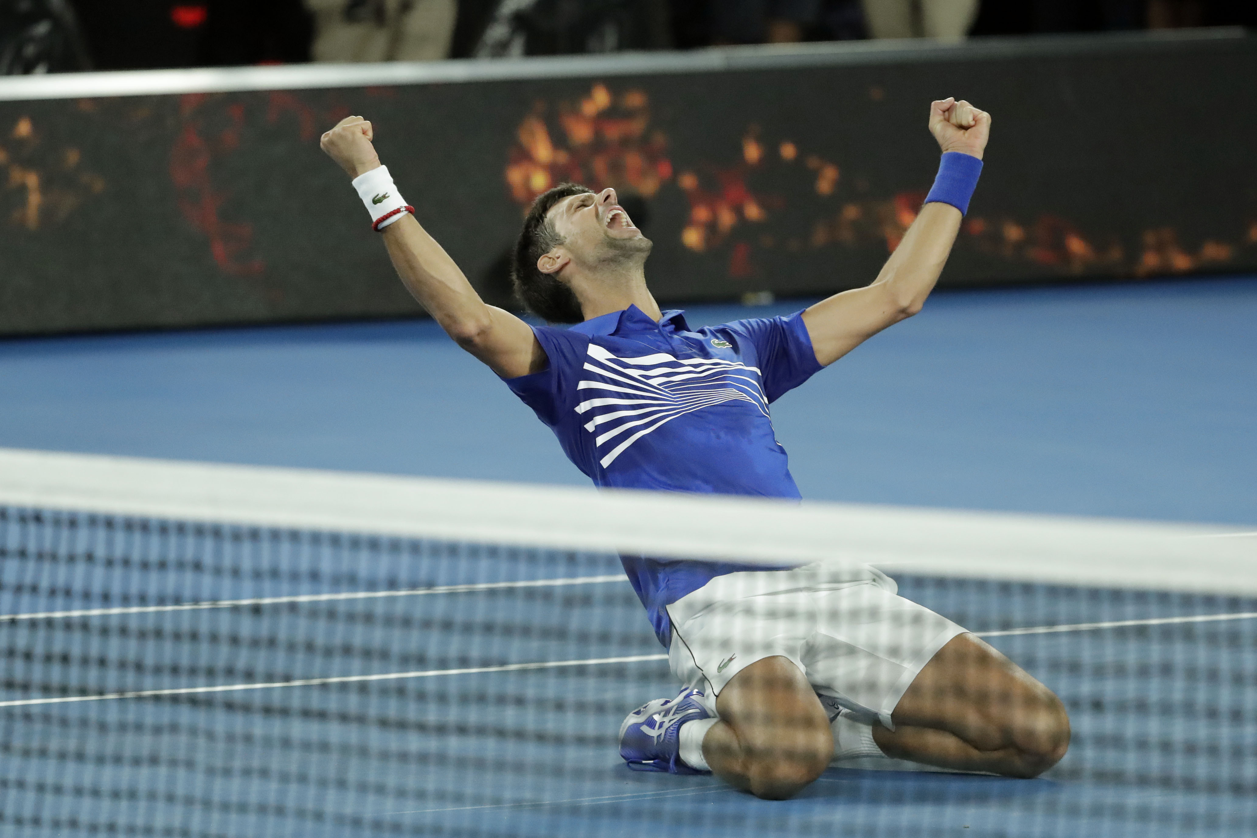 epa07323958 Novak Djokovic of Serbia celebrates winning his men's singles final match against Rafael Nadal of Spain at the Australian Open Grand Slam tennis tournament in Melbourne, Australia, 27 January 2019. EPA-EFE/MAST IRHAM